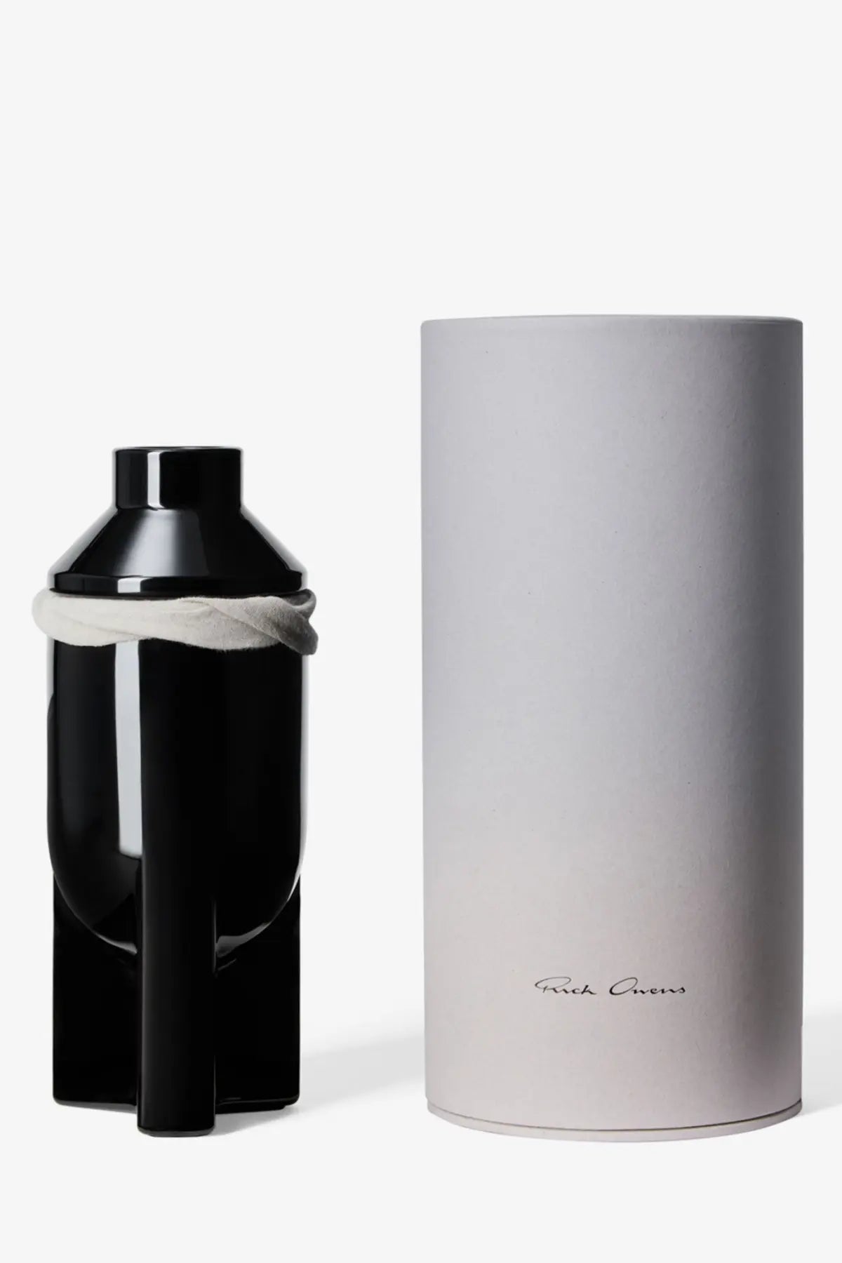 Black glossy ceramic bottle of rick owens unisex galss scented candle lapparition with white cloth tied around neck