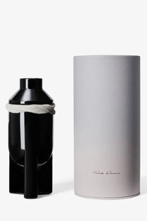 Black glossy ceramic bottle of rick owens unisex galss scented candle lapparition with white cloth tied around neck