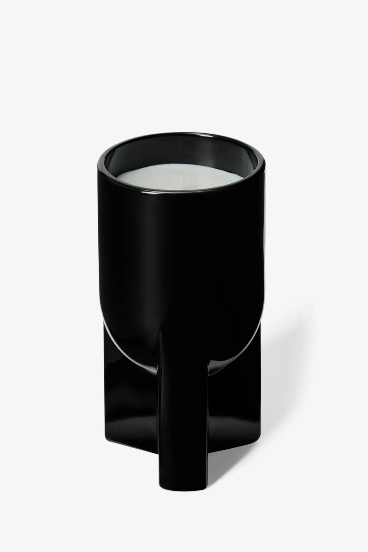 Black glossy ceramic candle holder with modern geometric base and cylindrical top for Rick Owens unisex scented candle