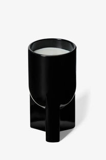 Black glossy ceramic candle holder with modern geometric base and cylindrical top for Rick Owens unisex scented candle