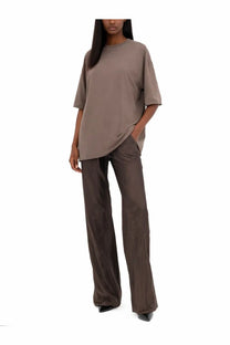 A loose-fitting taupe oversized t-shirt with short sleeves paired with rick owens women’s pants bias grey