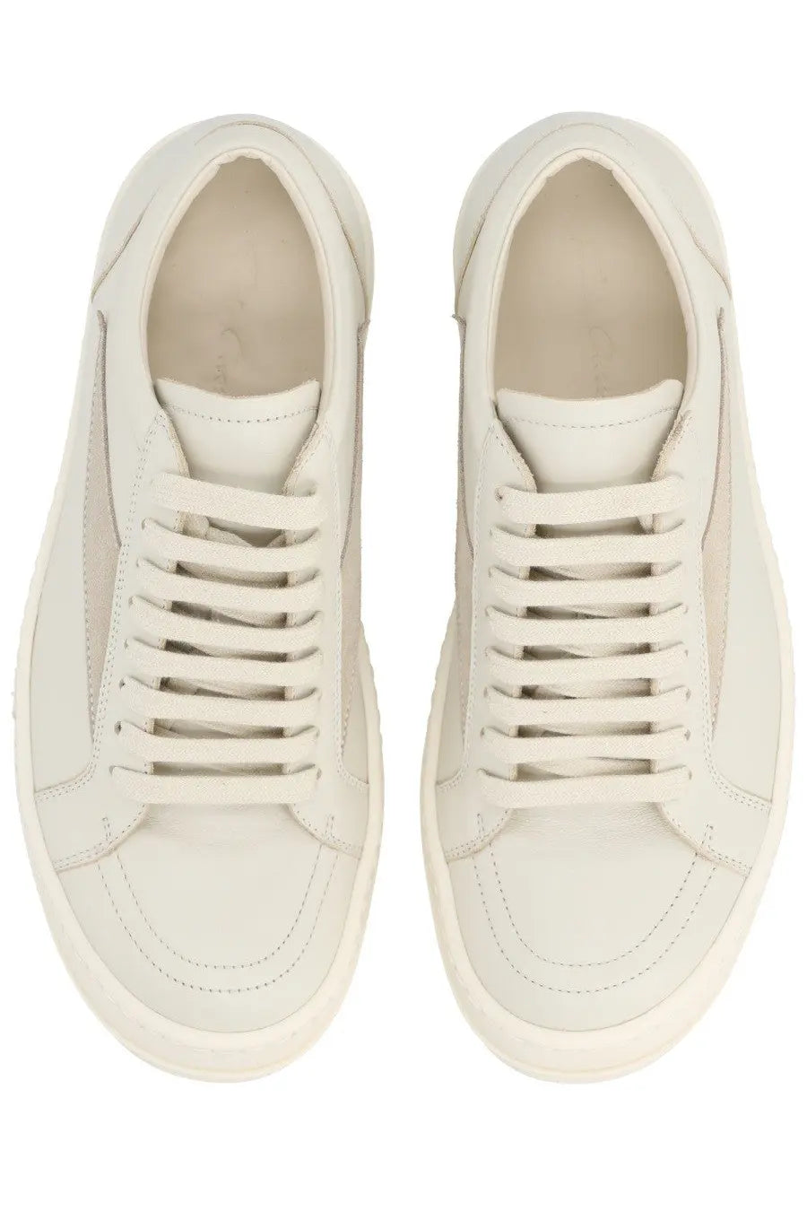 Cream-colored leather low-top Rick Owens women’s sneaker with white laces and matching rubber sole vintage sneaks white