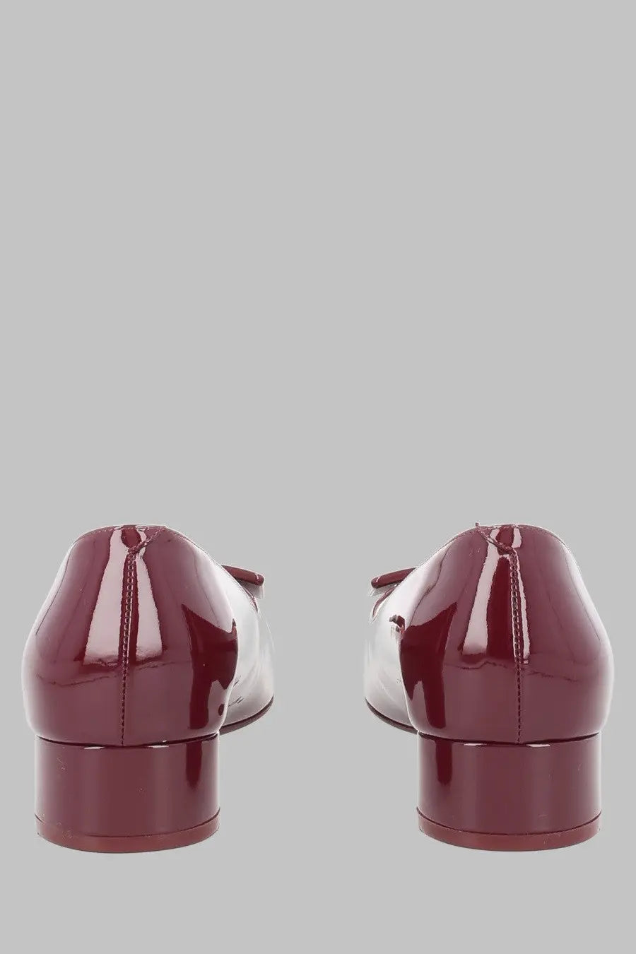 Back view of roger vivier women’s ballerina look burgundy patent leather flats with low block heel and bow detail