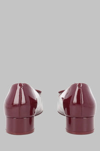 Back view of roger vivier women’s ballerina look burgundy patent leather flats with low block heel and bow detail