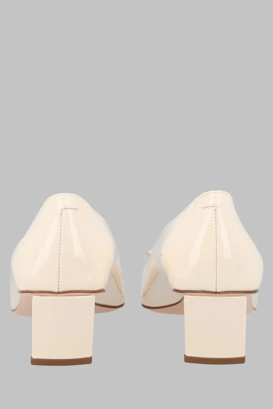 Cream-colored patent leather pumps with block heel and subtle stitching details by Roger Vivier in Vernice white