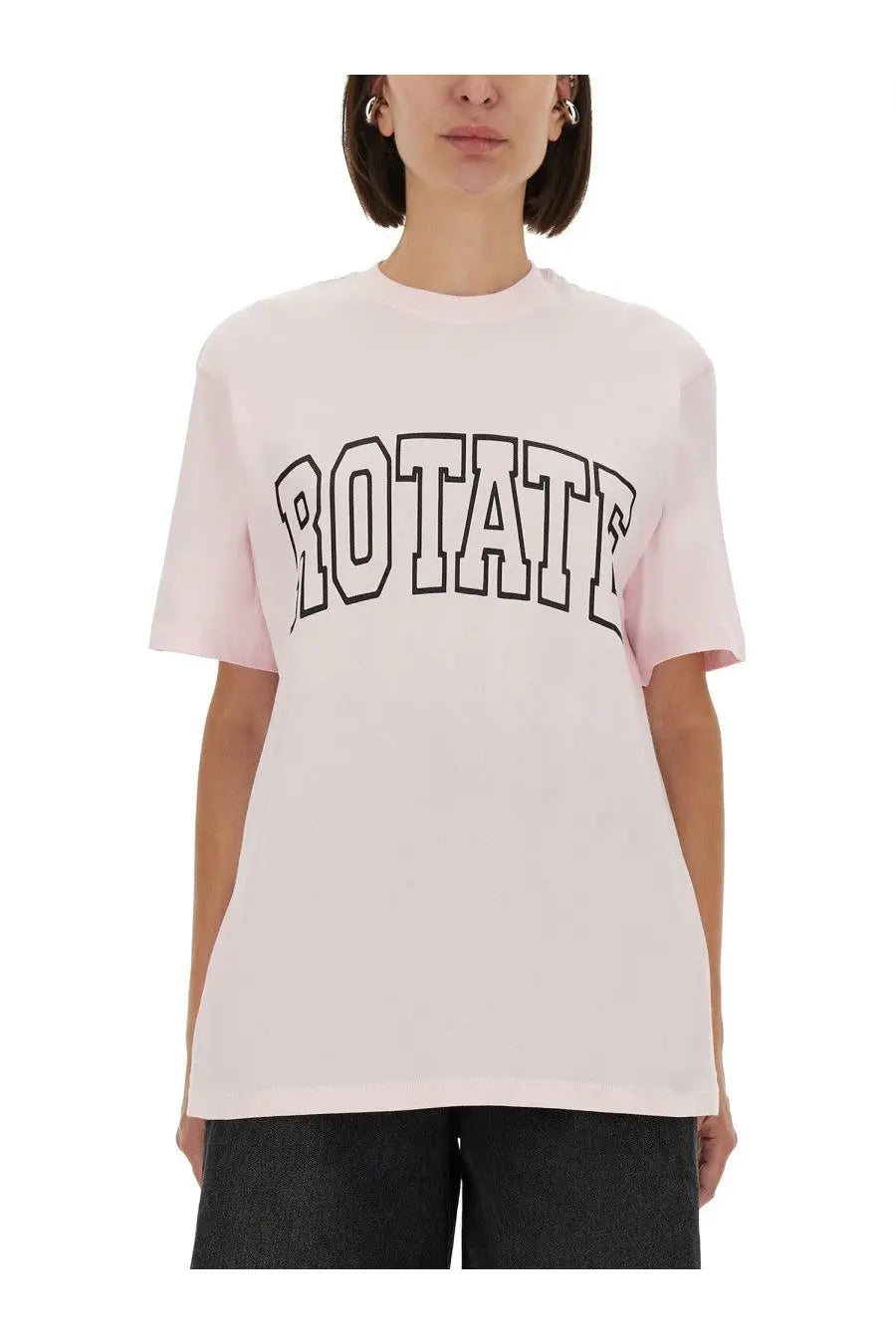 A soft pink oversized crewneck jersey t-shirt with bold black outlined rotate lettering by Rotate Birger Christensen