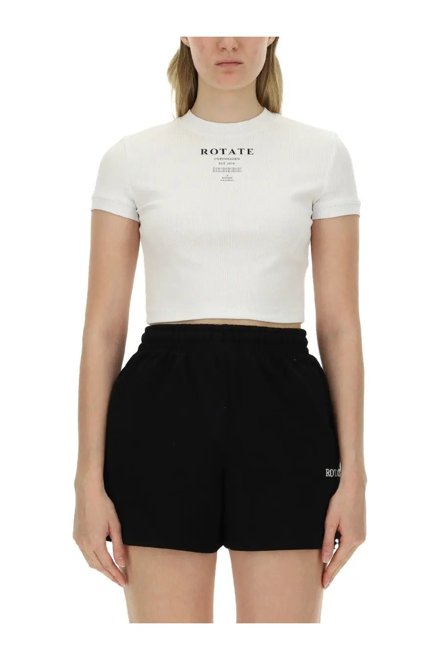 White short-sleeved crop top with black text print on chest from rotate birger christensen womens shirt collection