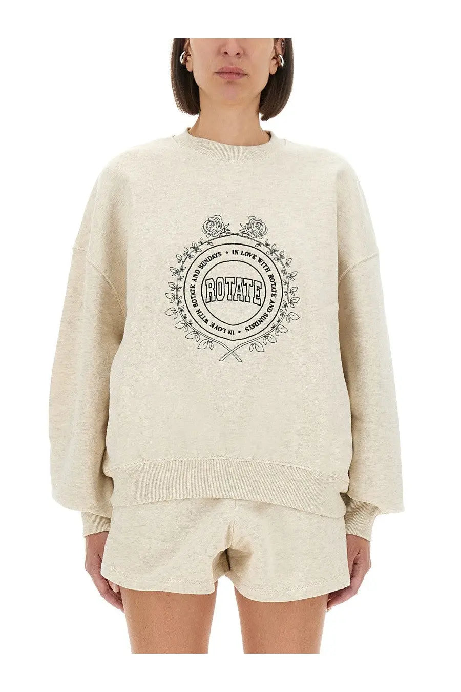 Cream-colored oversized rotate birger christensen women’s sweatshirt with black circular floral wreath graphic