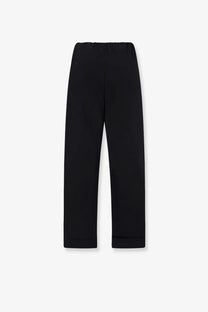 The Row women’s Delano black cotton trousers feature straight legs with smooth fabric and rolled cuffs