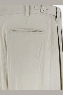 Beige linen trousers with buttoned waistband and subtle stitching details from the row womens iven silk and nylon trousers gray
