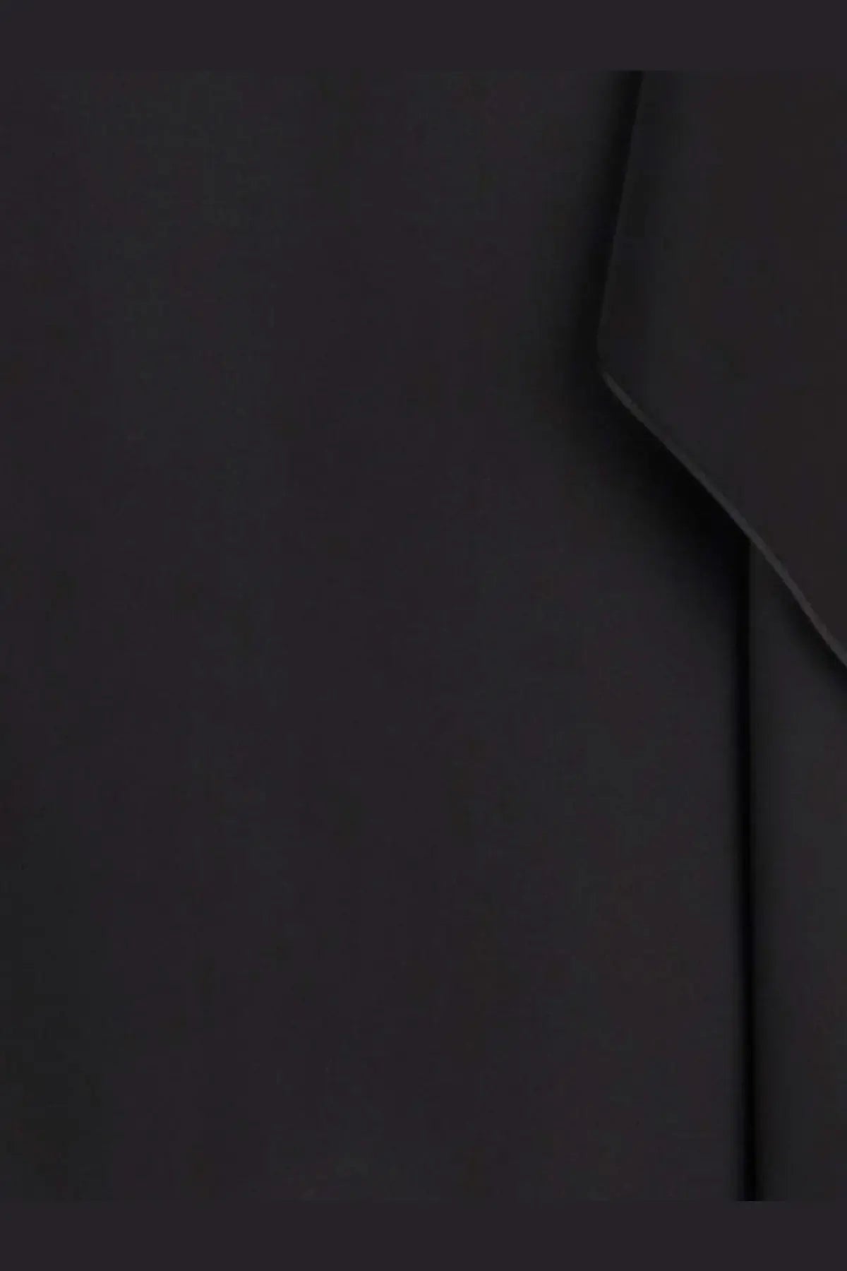 The row women’s koray silk top black showing smooth matte black silk fabric with subtle creases