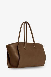 The row womens marlo leather shoulder bag brown is a sleek medium brown leather tote with structured handles