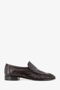 The row women’s soft mocassin two leather loafers in dark brown feature a frayed ruched toe and low block heel