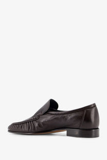 Dark brown leather loafer with sleek minimalist design and subtle pleated detailing on the toe by the row women