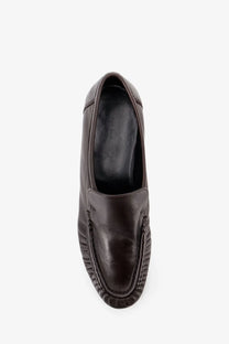 The row women’s soft mocassin two dark brown leather loafers with stitched toe seam and visible brand label inside