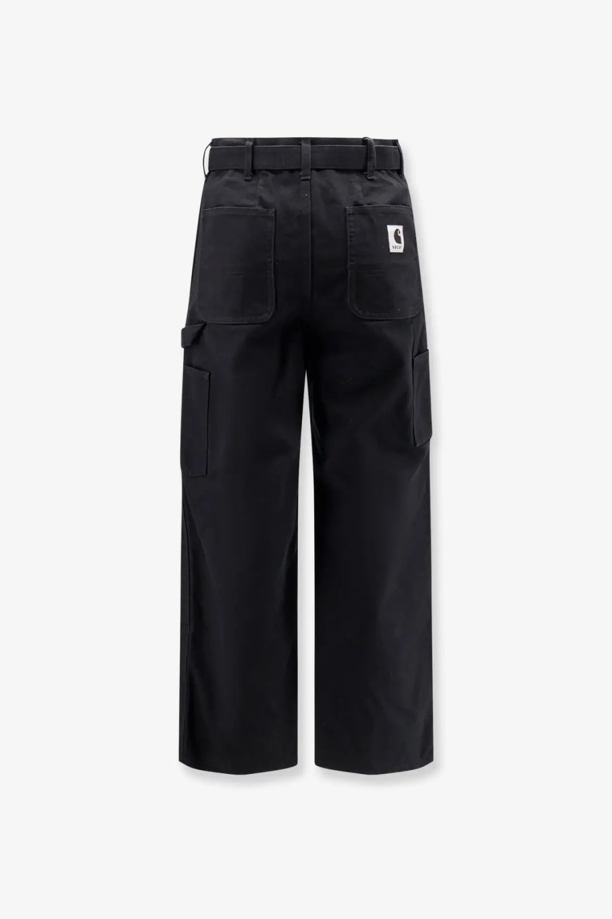 Back view of black sacai men’s carhartt wip duck cotton cargo pants with multiple pockets and branded patch