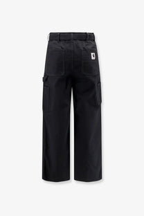 Back view of black sacai men’s carhartt wip duck cotton cargo pants with multiple pockets and branded patch