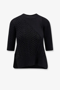 Sacai women’s black cotton blend knit sweater with three quarter sleeves cable knit and openwork mesh front design