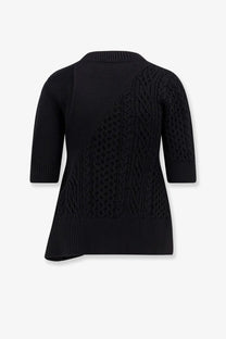 Sacai women’s black cotton blend sweater with asymmetrical diagonal cable knit pattern and ribbed cuffs