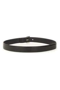 Saint Laurent men’s Cassandras belt black featuring a black leather strap with a minimalist silver-toned buckle