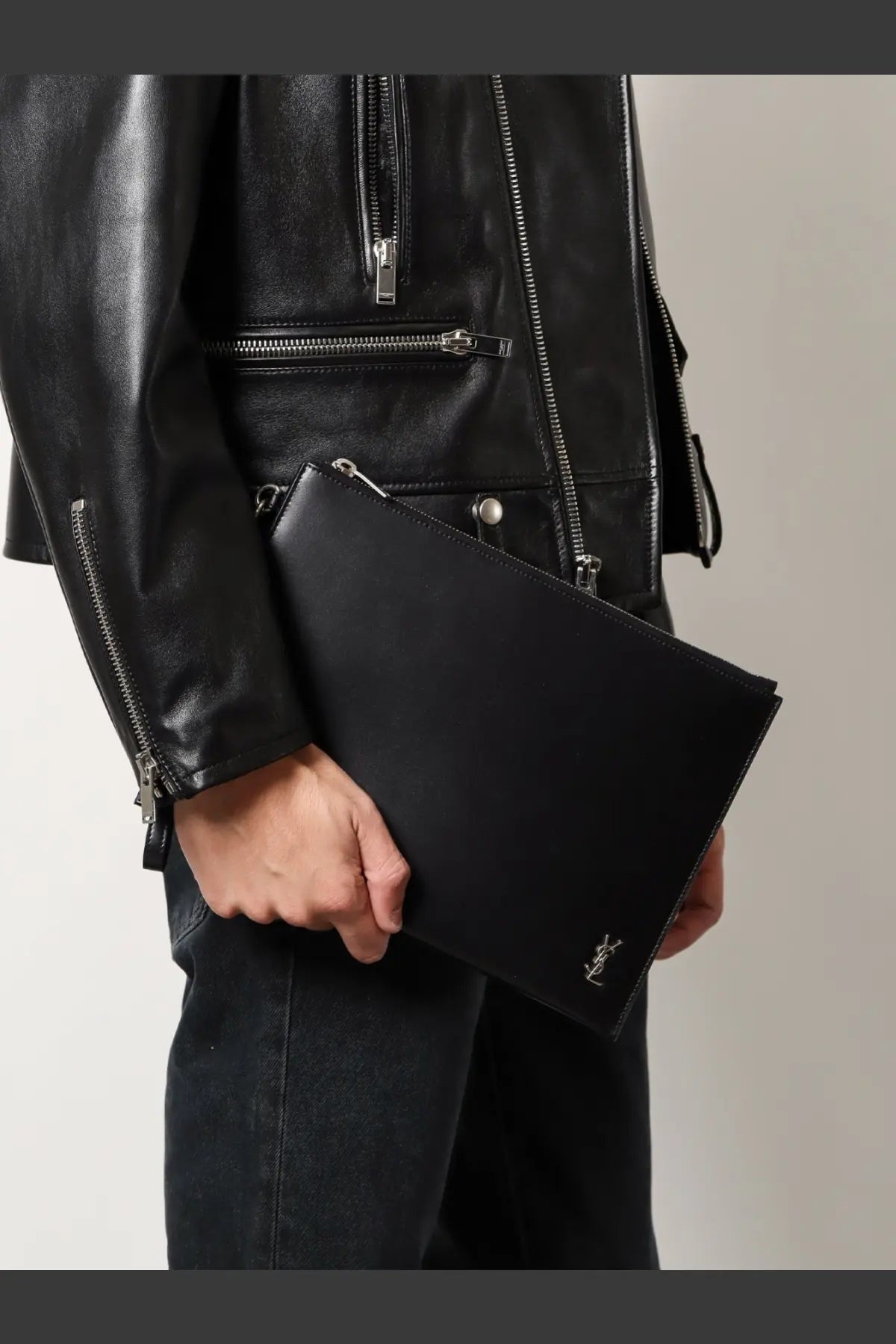Saint Laurent men’s black leather clutch with silver-tone YSL logo on the corner perfect for stylish essentials