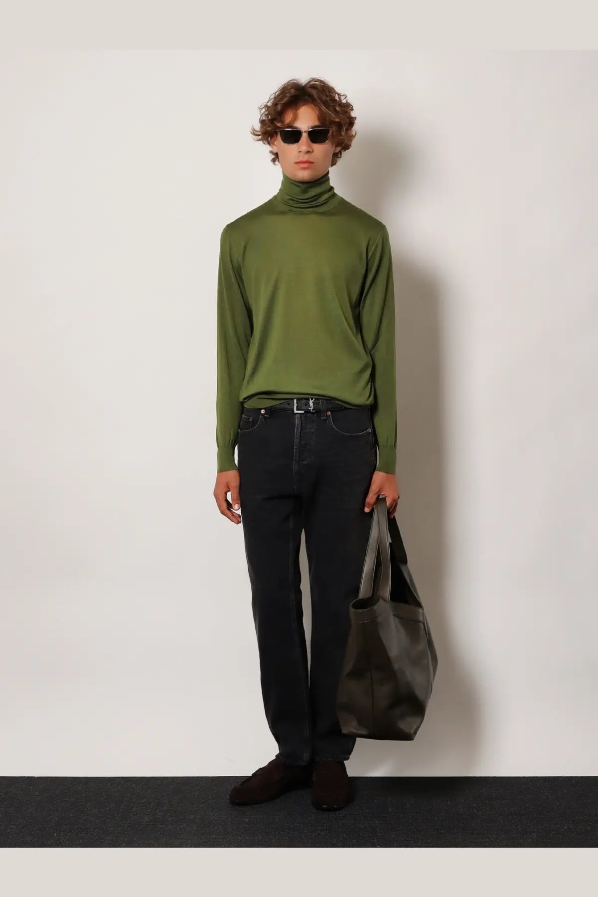 Olive green long-sleeved turtleneck sweater paired with saint laurent men’s long mick black denim trousers black