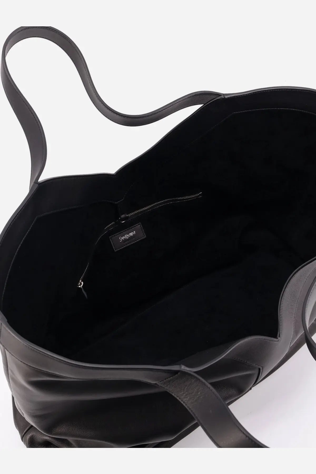 Saint Laurent men’s oversize black leather tote bag with soft wrinkled texture and minimalist design