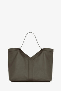 Saint Laurent men’s oversize leather tote bag in olive green with distinctive v-shaped front panel and thin black handles