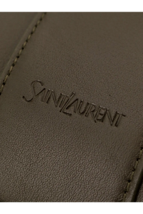 A taupe leather wallet with the saint laurent logo embossed paired with a green men’s oversize leather tote bag