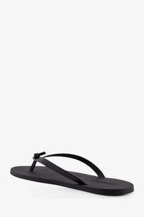 Saint Laurent men’s party low black rubber sandals with a minimalist design and small knot detail on the toe strap