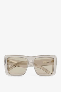 Saint Laurent women’s clear rectangular acetate sunglasses with beige tinted lenses and gold-tone branding on temples