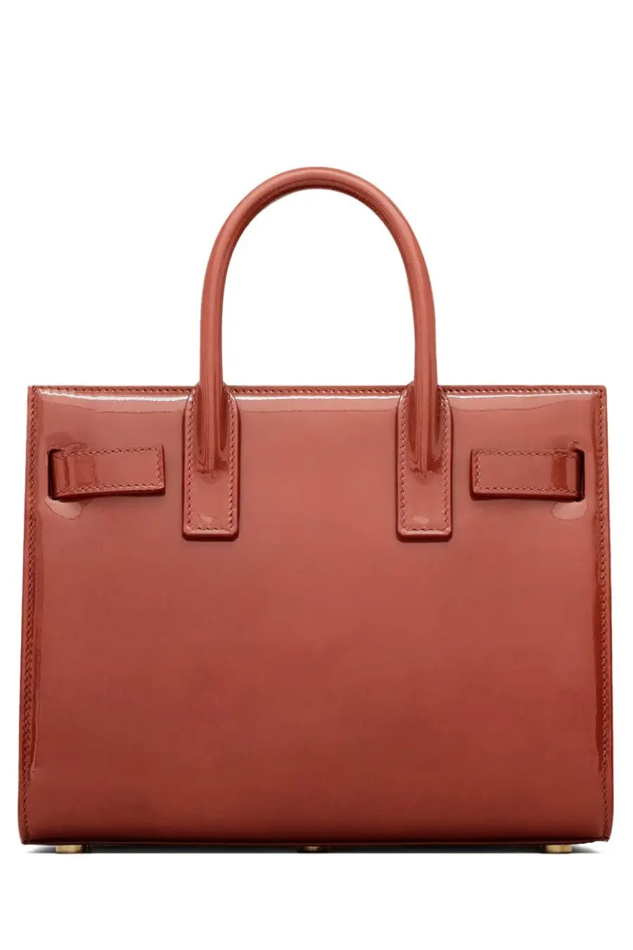 A glossy terracotta-colored saint laurent sac de jour nano tote bag with structured design and top handles
