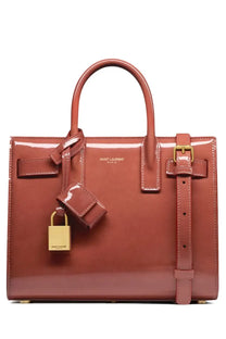 Saint Laurent women’s glossy terracotta leather sac de jour nano bag with gold hardware and matching lock