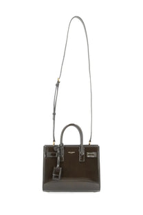 Saint Laurent women’s small baguette handbag in dark brown glossy leather with gold hardware and top handles