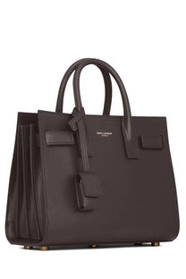 Dark brown leather saint laurent women’s sac de jour nano bag with gold-tone hardware and structured design