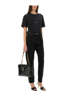 Black quilted leather YSL handbag with gold-tone chain strap and logo hardware shown with Saint Laurent boyfriend fit shirt