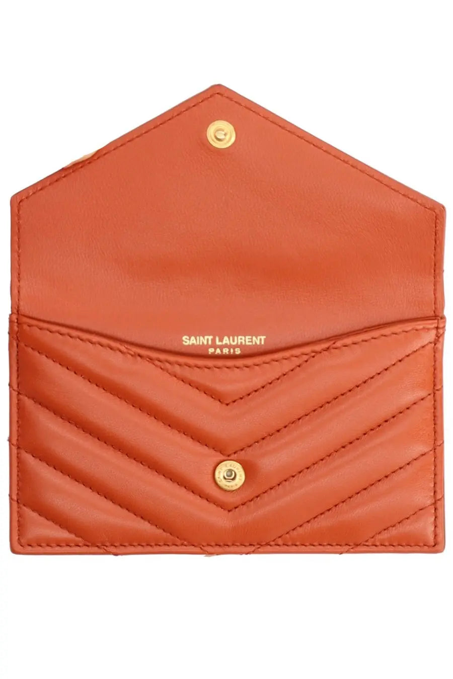 A coral-colored Saint Laurent Paris quilted chevron card holder with gold-tone hardware in Cassandras red