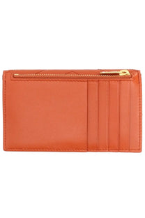 Saint Laurent women’s orange leather card holder with gold-tone zipper and vertical slots for cards
