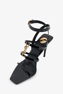 Saint Laurent women’s cassandre black patent leather strappy high heel sandals with gold-tone ysl logo hardware