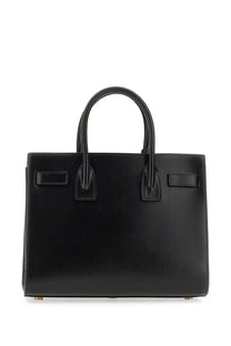 Saint Laurent women’s classic baby sac de jour tote bag in black leather with structured rectangular shape and top handles