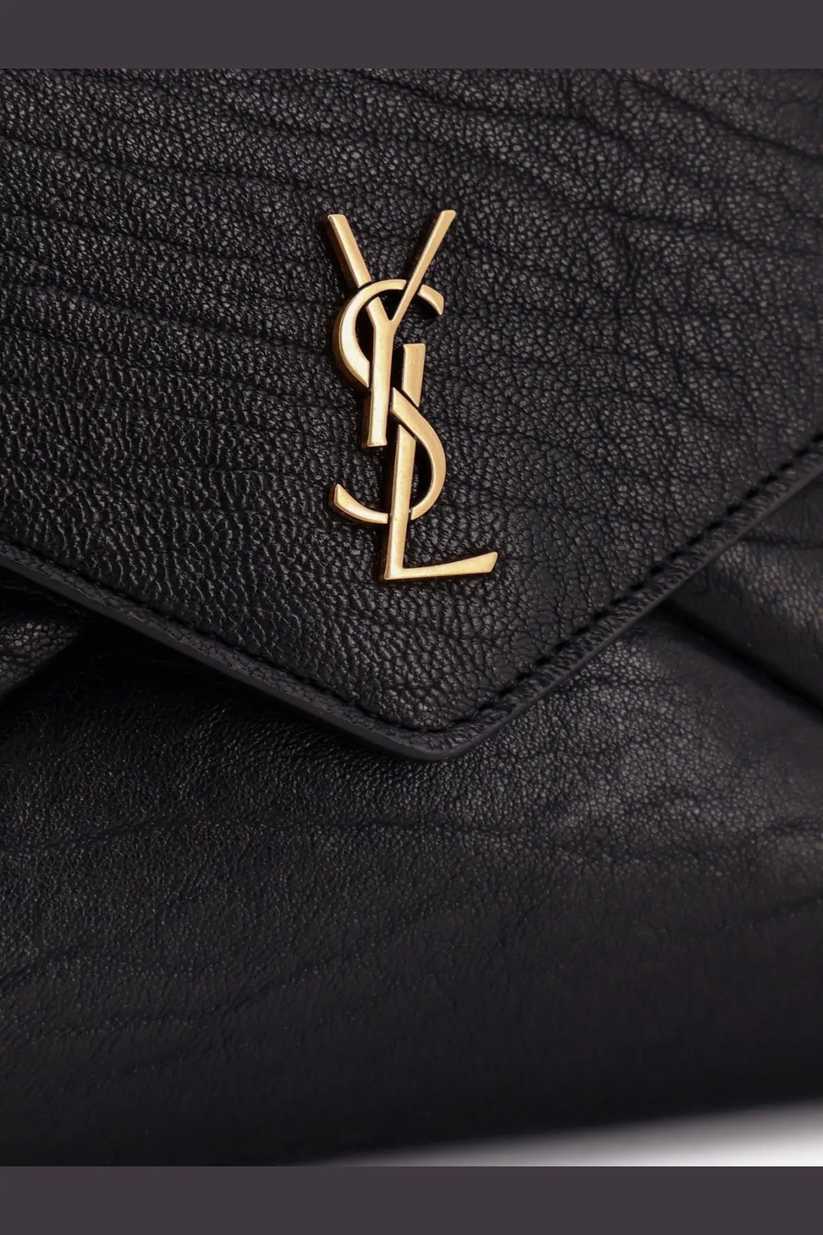Saint Laurent women’s black leather crossbody bag featuring textured leather and a gold-tone YSL logo emblem