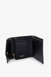 Saint Laurent women’s black leather trifold wallet with gold-tone hardware and Saint Laurent Paris embossing inside