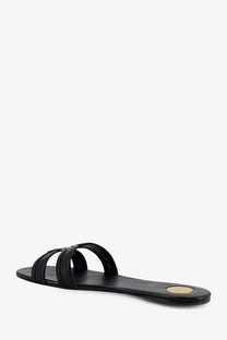 Saint Laurent women’s mabrouka black leather slide sandal with minimalist design and gold circular heel accent