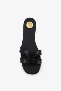 Black leather slide sandal with gold-tone circular saint laurent logo on the back heel women’s mabrouka sandals