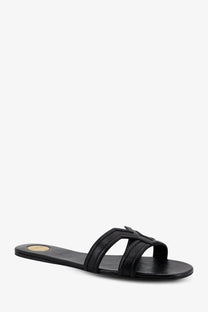 Saint Laurent women’s Mabrouka black leather slide sandal with minimalist design and small gold insole logo
