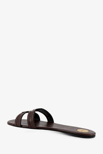 Brown leather slide sandal with thin straps and gold circular logo on the heel back side saint laurent womens mabrouka
