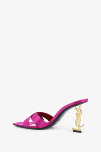 Saint Laurent women’s Opyum satin mule sandal in fuchsia with gold-tone YSL logo heel shown from the back side