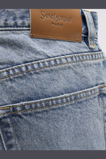 Light-wash denim saint laurent women’s relaxed straight jeans with brown leather brand label on the waistband back side