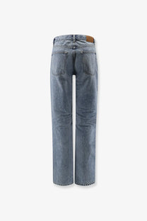 Saint Laurent women’s relaxed straight jeans in light-wash denim with a brown leather brand patch at the waistband