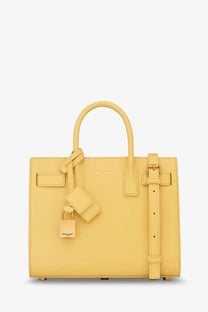 Saint Laurent women’s sac de jour nano leather crossbody bag in pale yellow with top handles and detachable shoulder strap